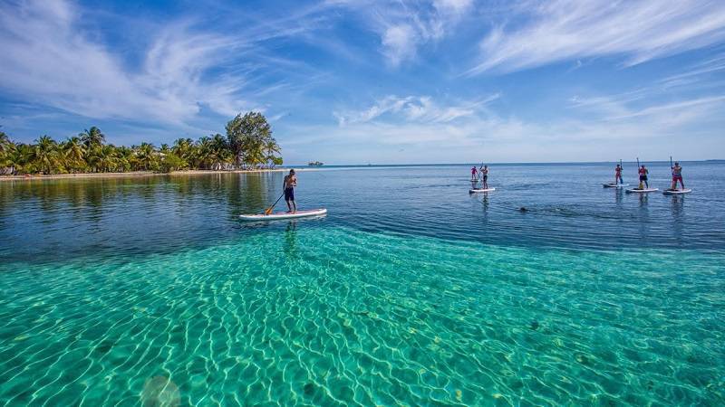 Belize beach and boat with a man