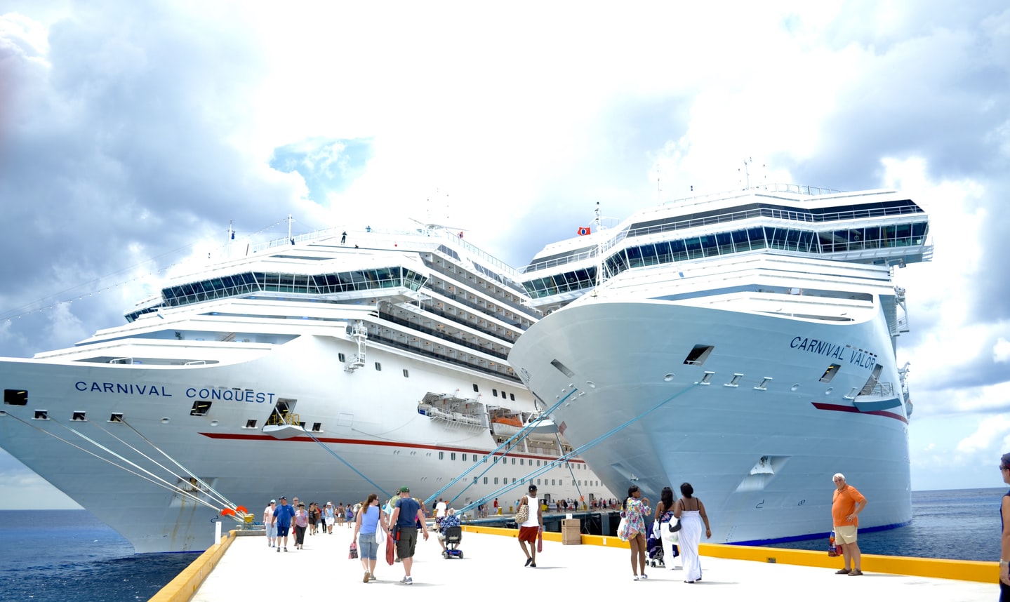 two Carnival Cruise ships on a pier