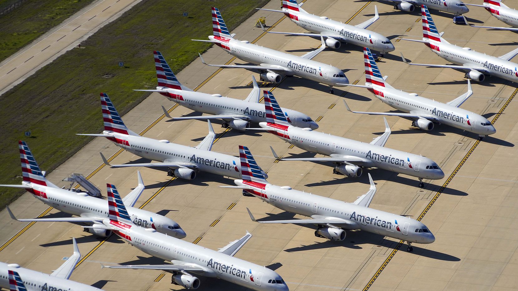 AA planes lined up on tarmac, viewed from above