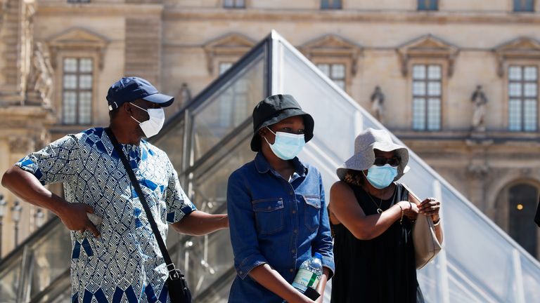 people wearing face masks in Paris, The Louvre Museum