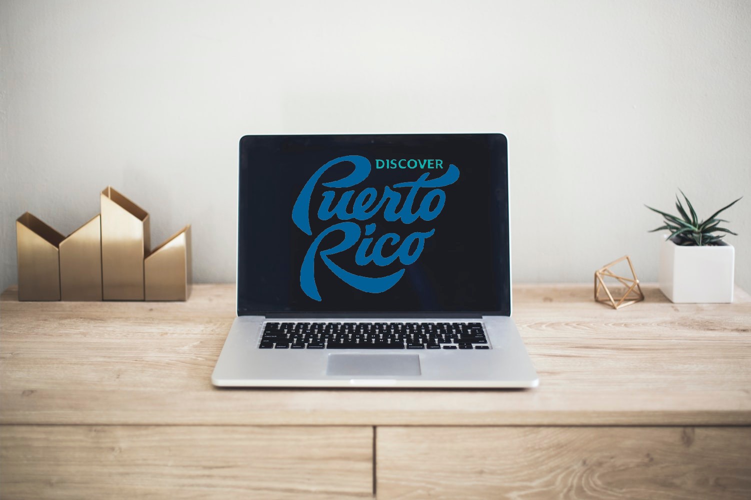 laptop on desk with the Discover Puerto Rico logo on the screen