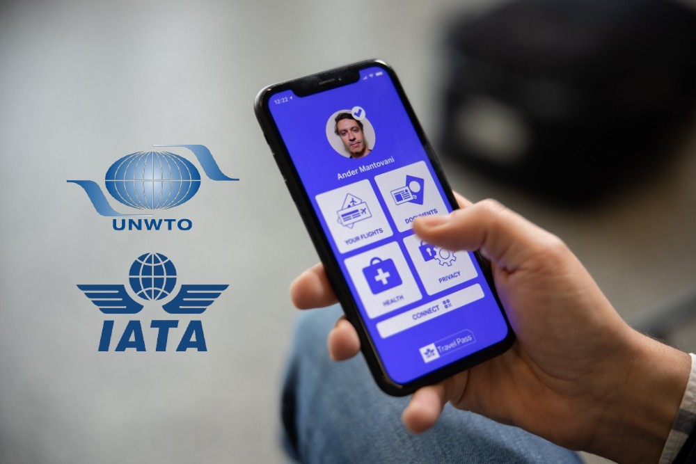 smartphone in hand and IATA and UNWTO logos