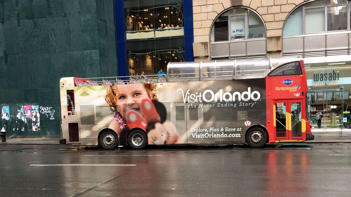 bus with Visit Orlando banner on it