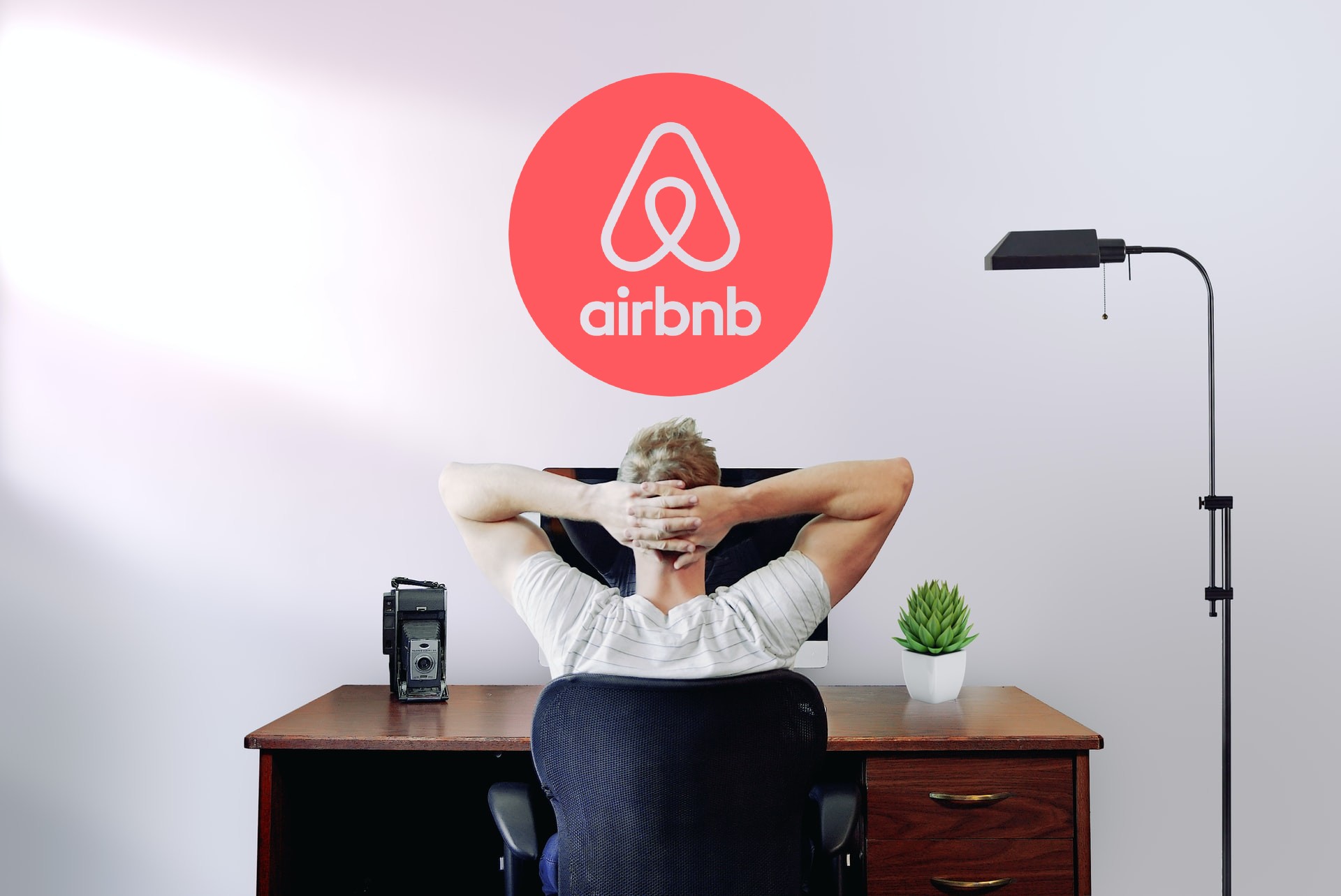 man with arms on the back of his neck and Airbnb logo on top
