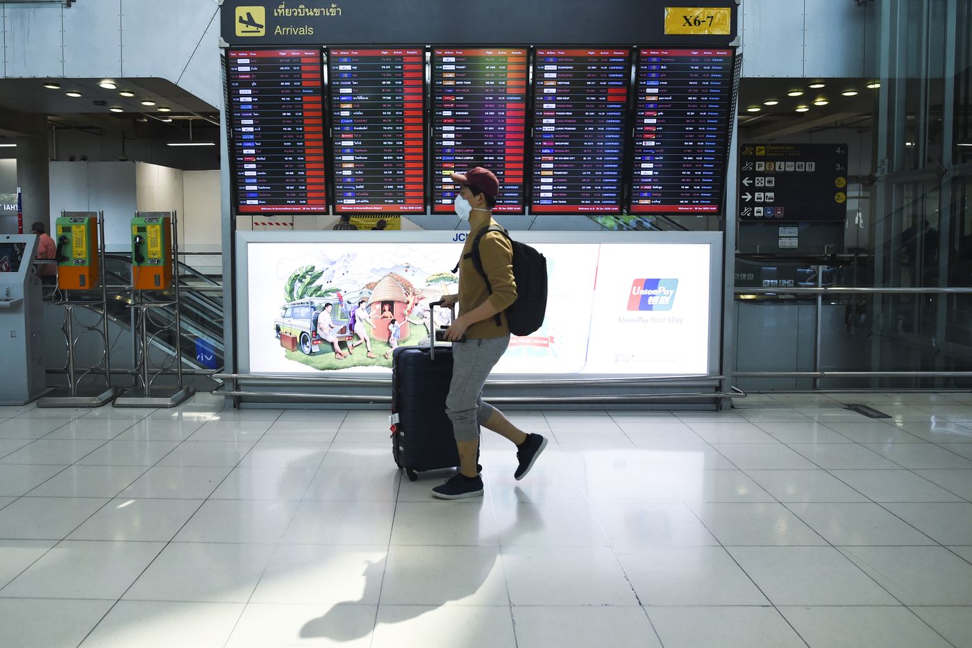passenger walking down airport aisle