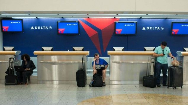 empty Delta counters and passengers sitting there