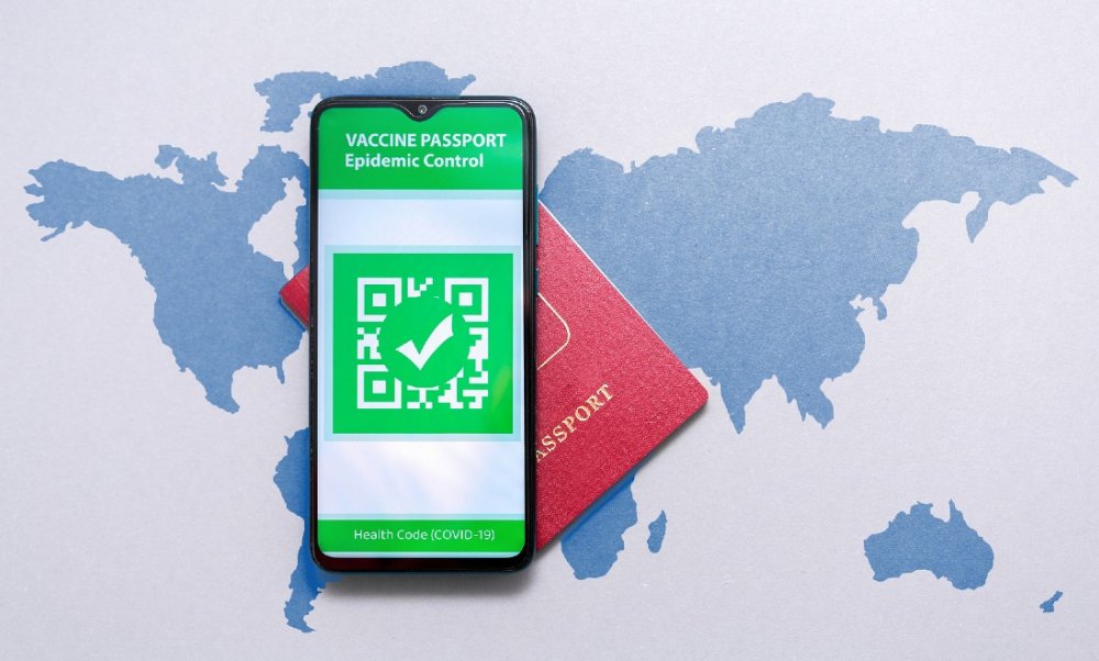 passport and vaccination green pass on a map