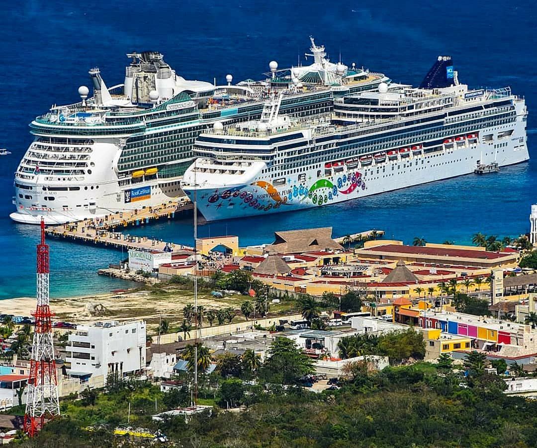 RCCL and Norwegian cruise ships side by side in a terminal