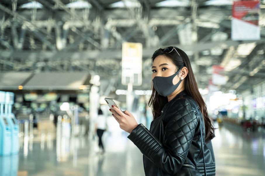 woman wearing face mask at airport