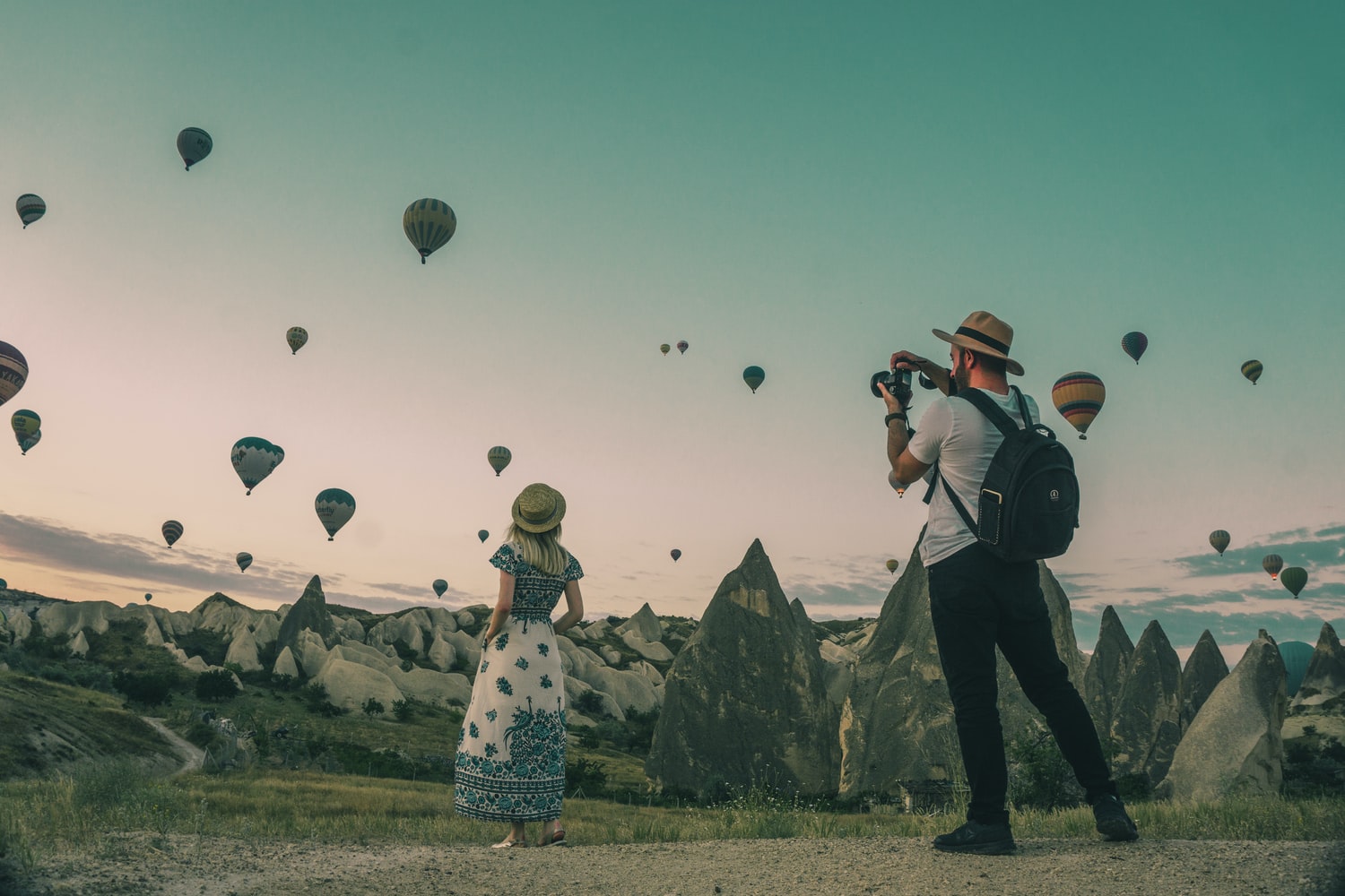 couple photographing balloons