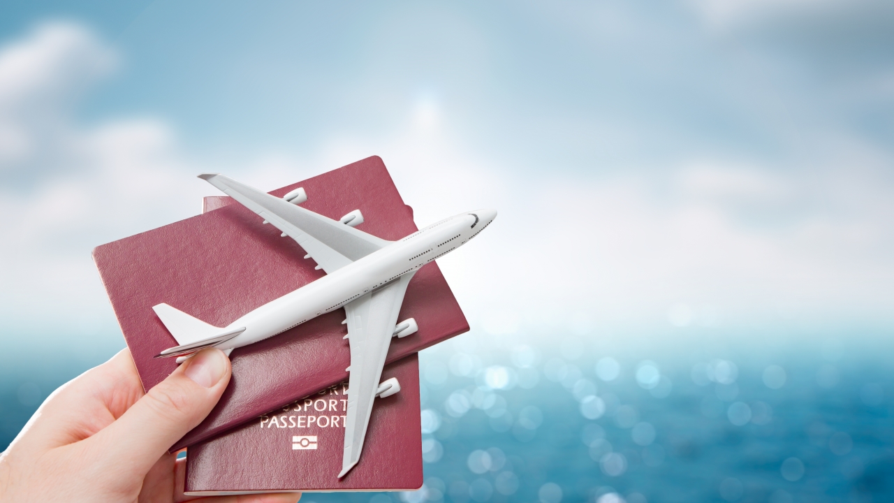 passports and plane in hand